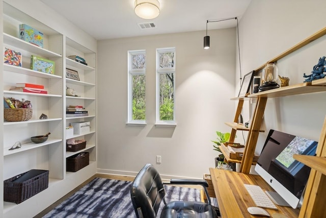 office space with baseboards and visible vents