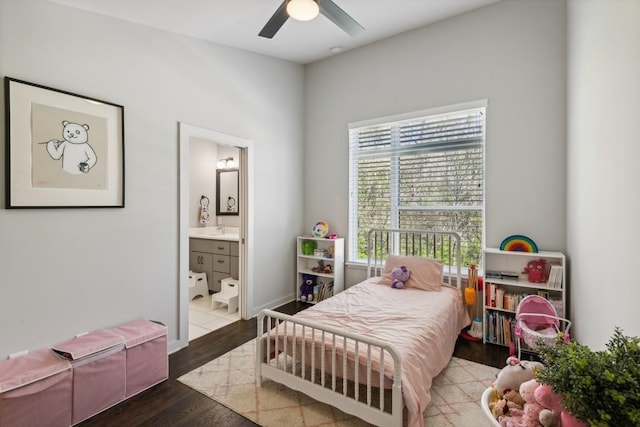 bedroom with ensuite bathroom, a ceiling fan, and wood finished floors