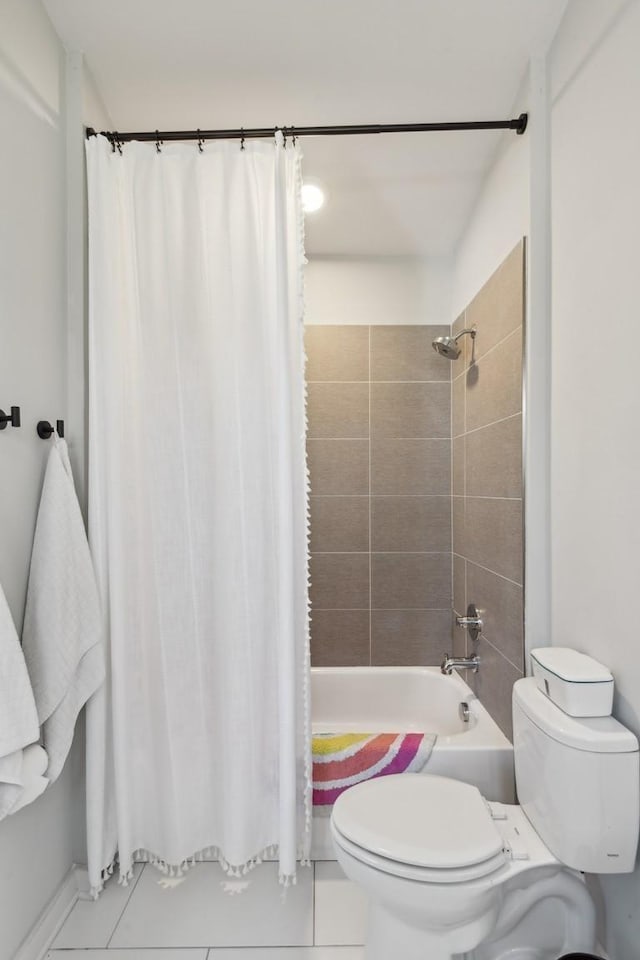 bathroom featuring tile patterned floors, toilet, and shower / bathtub combination with curtain