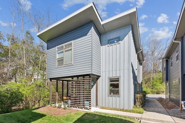 exterior space featuring a lawn and board and batten siding