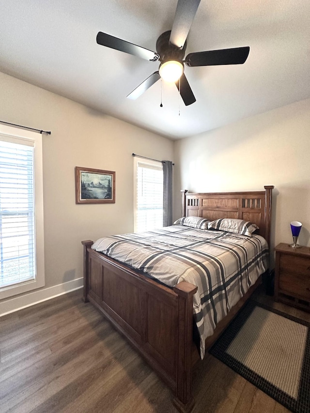 bedroom with wood finished floors, baseboards, and ceiling fan