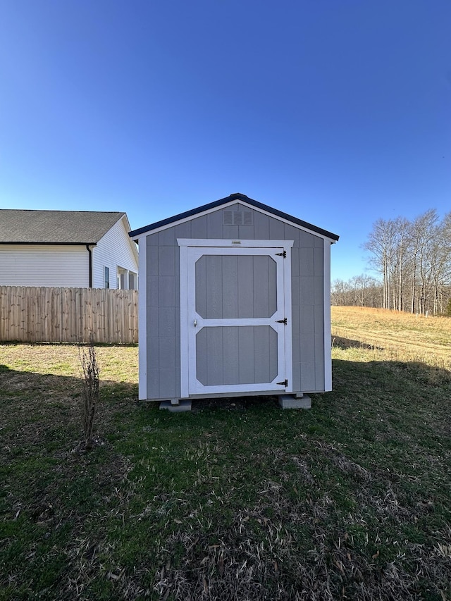 view of shed featuring fence