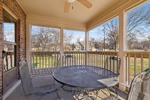 sunroom / solarium featuring a residential view