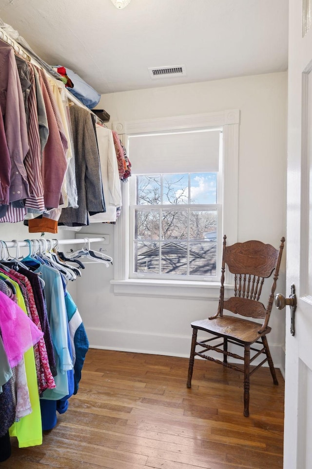 spacious closet featuring wood finished floors and visible vents