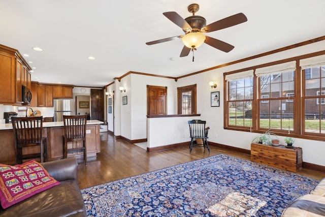 living room featuring baseboards, plenty of natural light, dark wood-type flooring, and crown molding