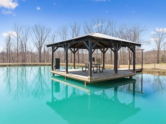 view of pool with a gazebo and a water view