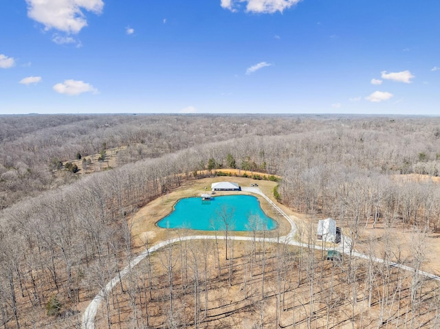 drone / aerial view featuring a forest view