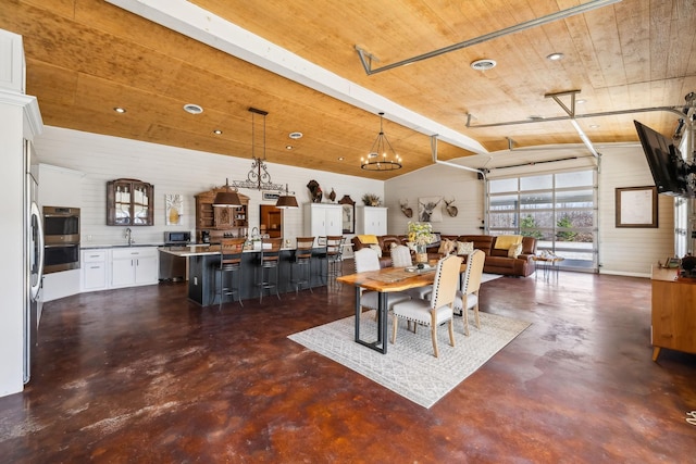 dining area with vaulted ceiling, wood ceiling, visible vents, and concrete flooring