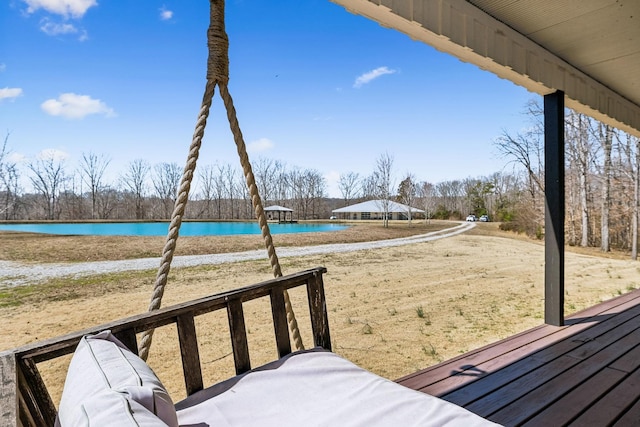 view of yard with a swimming pool and a water view