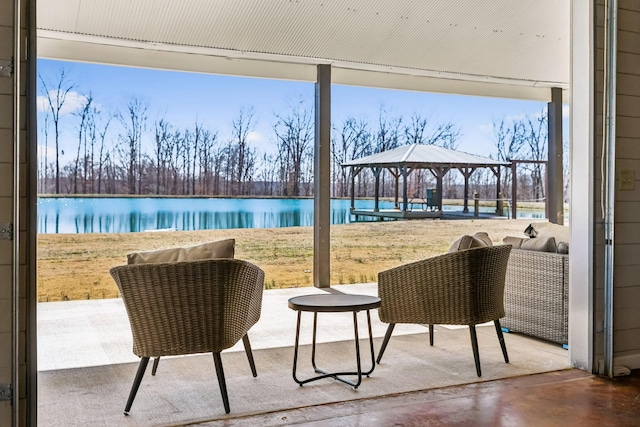 view of patio with a gazebo and a water view