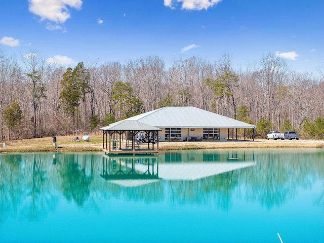 view of pool featuring a gazebo, a forest view, and a water view