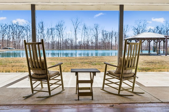 view of patio / terrace with a gazebo and a water view