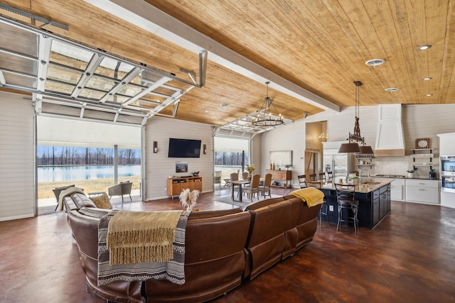 living room with wood ceiling, visible vents, concrete flooring, and a chandelier