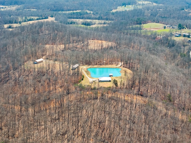 drone / aerial view featuring a view of trees