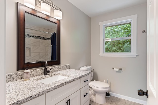 full bath with tile patterned floors, toilet, a tile shower, baseboards, and vanity