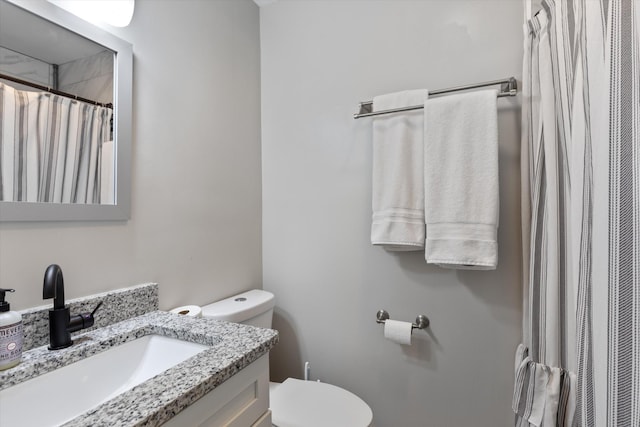 full bathroom with vanity, curtained shower, and toilet