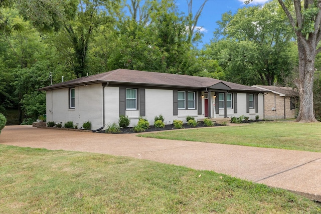 single story home featuring a front lawn and brick siding