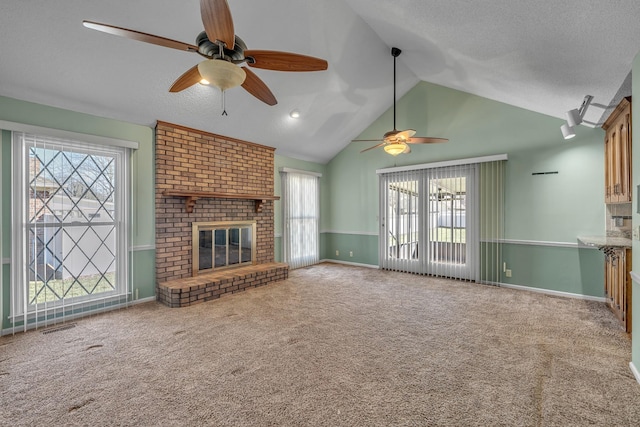 unfurnished living room with carpet flooring, a fireplace, visible vents, and vaulted ceiling