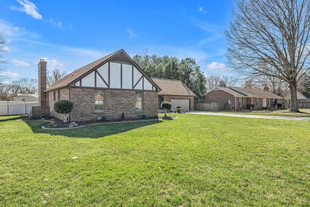 tudor house with a chimney, concrete driveway, brick siding, and fence