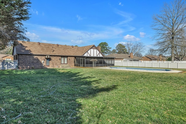 view of yard with a fenced in pool, a fenced backyard, and a sunroom