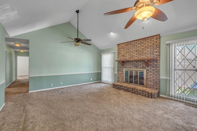 unfurnished living room featuring carpet, vaulted ceiling, a fireplace, and visible vents