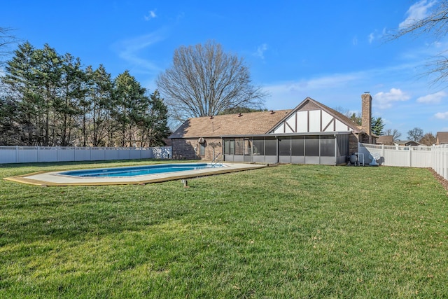 view of yard with a fenced backyard, a fenced in pool, and a sunroom