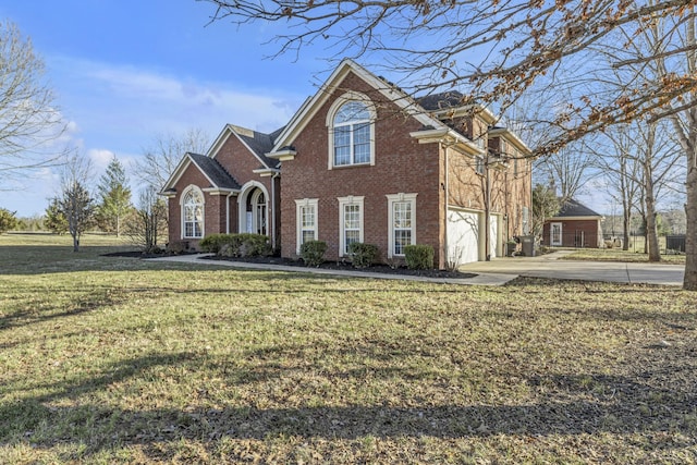 traditional-style home with brick siding, a garage, driveway, and a front lawn