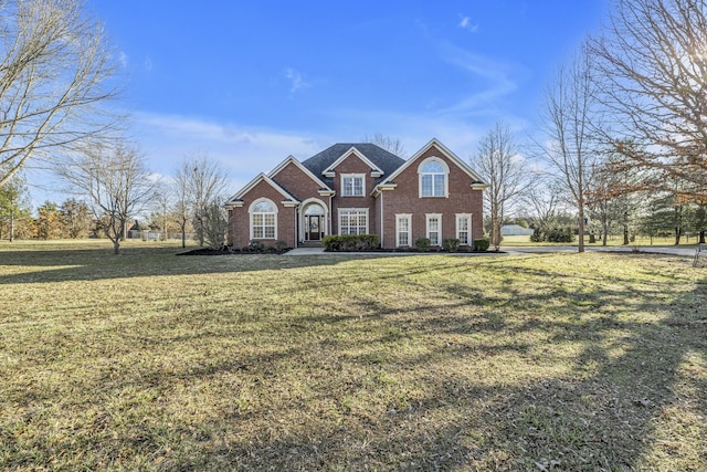 view of front of home with brick siding and a front lawn