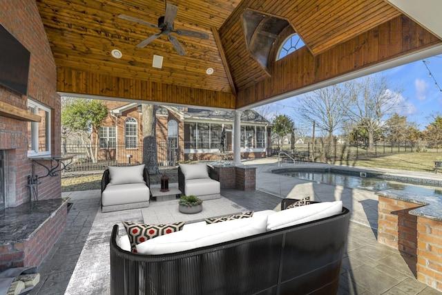 view of patio featuring an outdoor pool, ceiling fan, outdoor lounge area, and fence