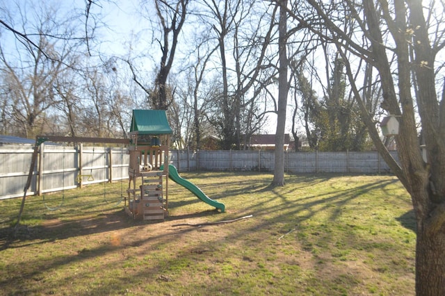 view of yard featuring a playground and fence