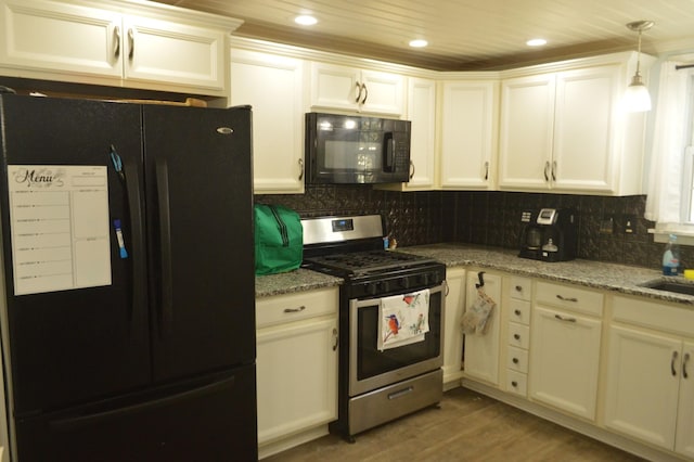 kitchen with light stone countertops, decorative backsplash, recessed lighting, wood finished floors, and black appliances