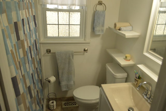 bathroom featuring visible vents, curtained shower, toilet, and vanity