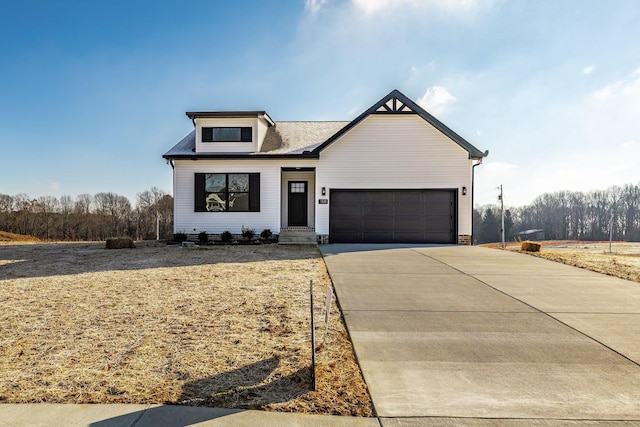 view of front of property featuring concrete driveway and a garage