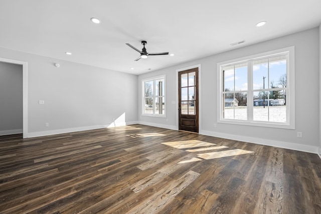 unfurnished living room with recessed lighting, visible vents, baseboards, and dark wood finished floors