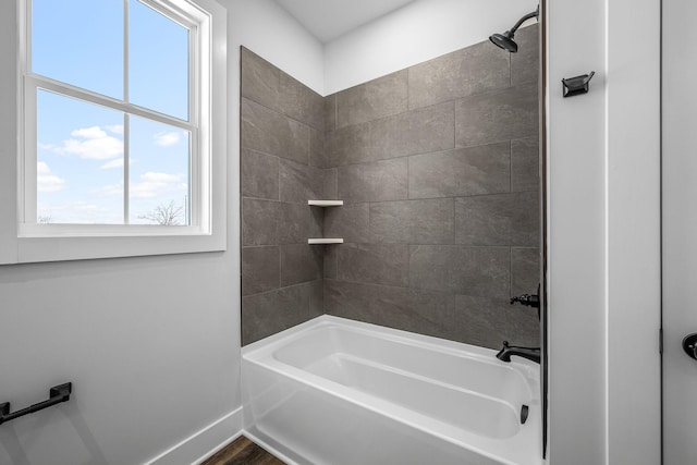 full bathroom featuring tub / shower combination and baseboards