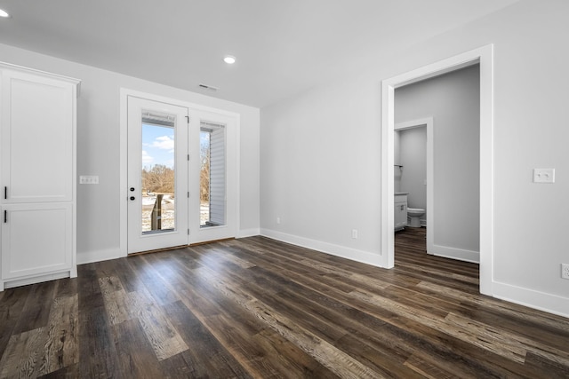 empty room with recessed lighting, visible vents, baseboards, and dark wood-style floors