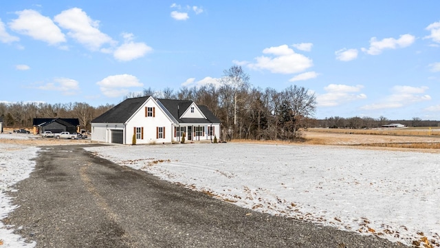 view of front of house with a porch, a garage, and driveway