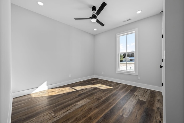 unfurnished room with recessed lighting, visible vents, baseboards, and dark wood-style flooring