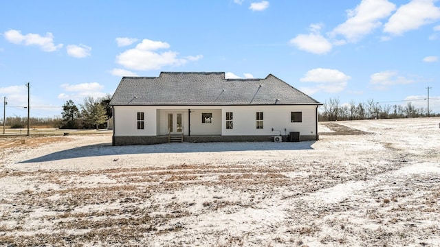 back of house featuring central air condition unit, french doors, and roof with shingles