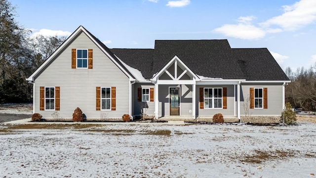 view of front of property featuring a shingled roof