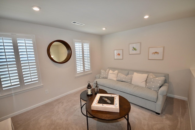 living area with recessed lighting, visible vents, baseboards, and carpet