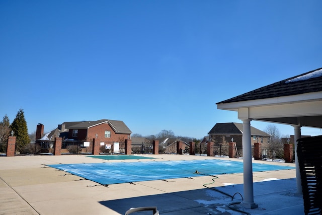 community pool featuring a patio and fence