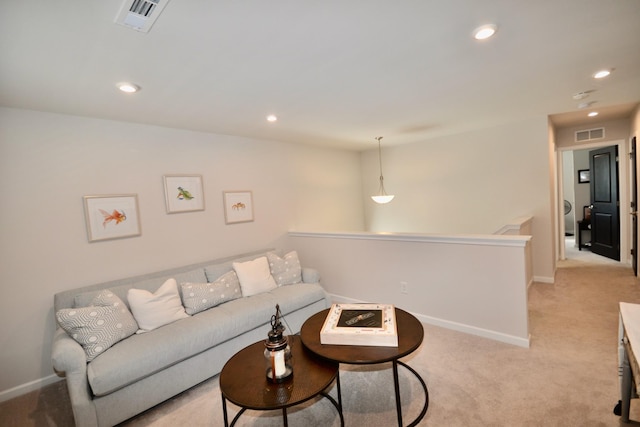 living area with baseboards, recessed lighting, visible vents, and light carpet