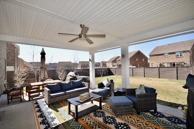 view of patio / terrace featuring an outdoor hangout area, a fenced backyard, and a ceiling fan