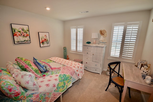 bedroom with recessed lighting, light colored carpet, and visible vents