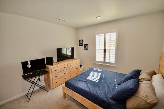 bedroom featuring light carpet, visible vents, and baseboards