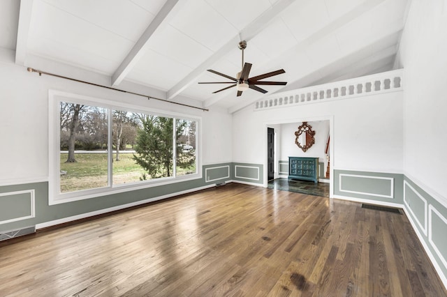 unfurnished living room featuring vaulted ceiling with beams, wood finished floors, visible vents, and ceiling fan