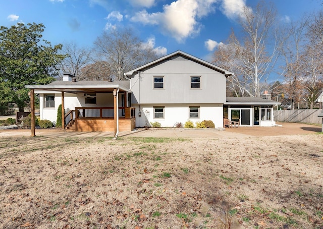 rear view of property with a patio and fence