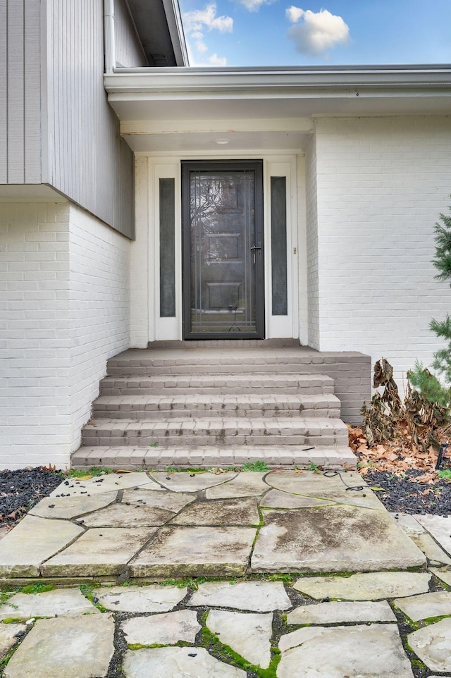 property entrance with brick siding