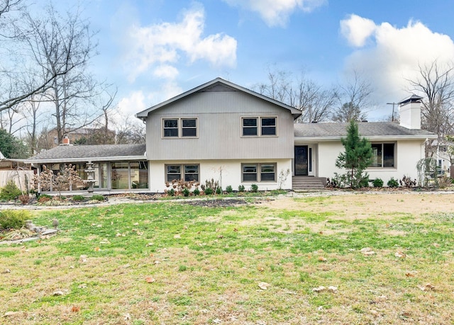 view of front of home with a front lawn and a chimney